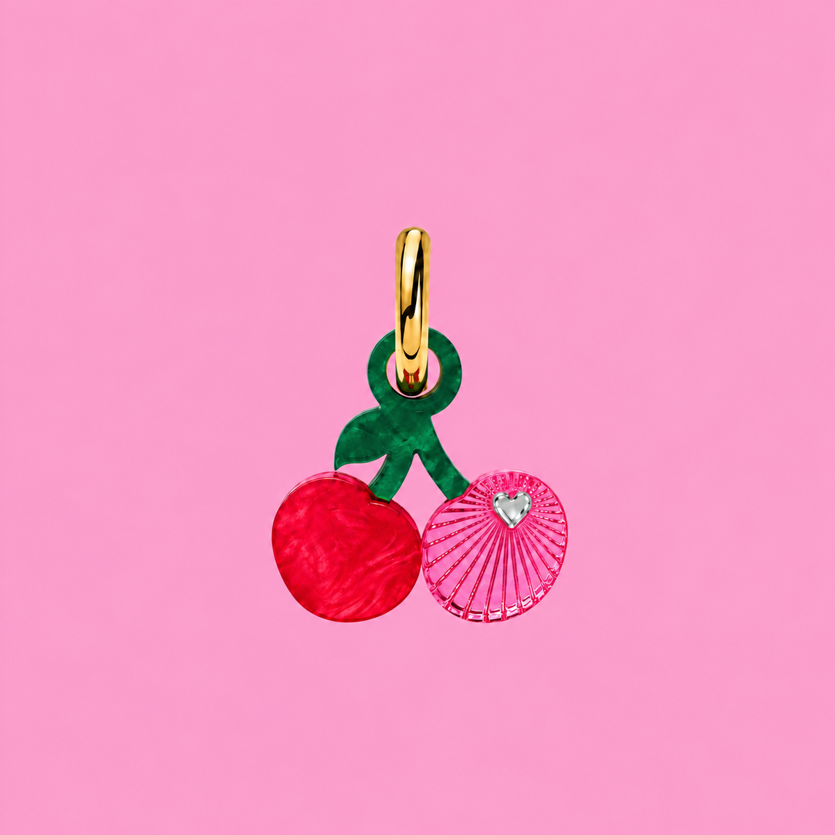 Weezy Pop cherry charm in red and pink acrylic, shown on a pink background